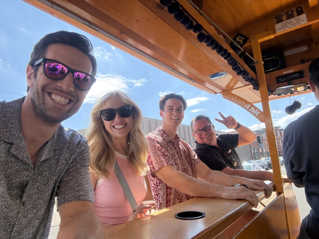 Agents riding the Pedal Hopper through RiNo